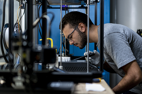 Student interacting with lab equipment