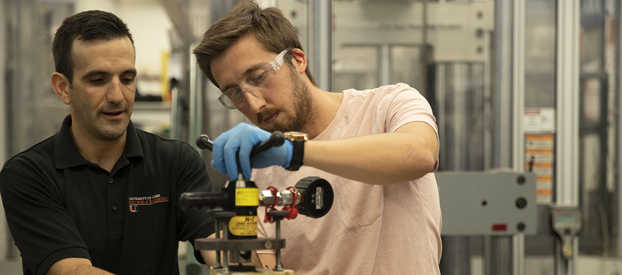 student and a professor working in a lab