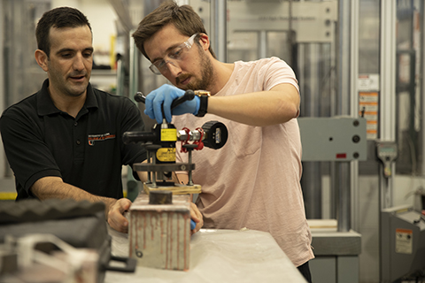 student and a professor working in a lab