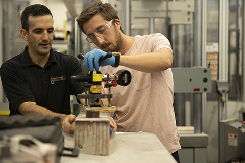 student and a professor working in a lab