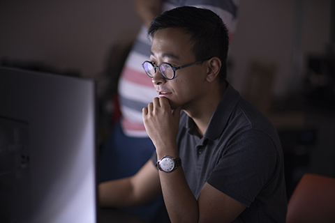 student working at a computer workstation