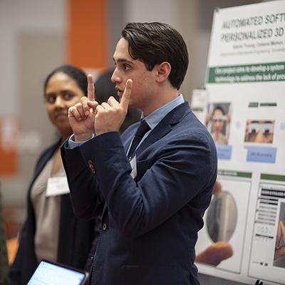 Student showcasing his project at the senior design expo